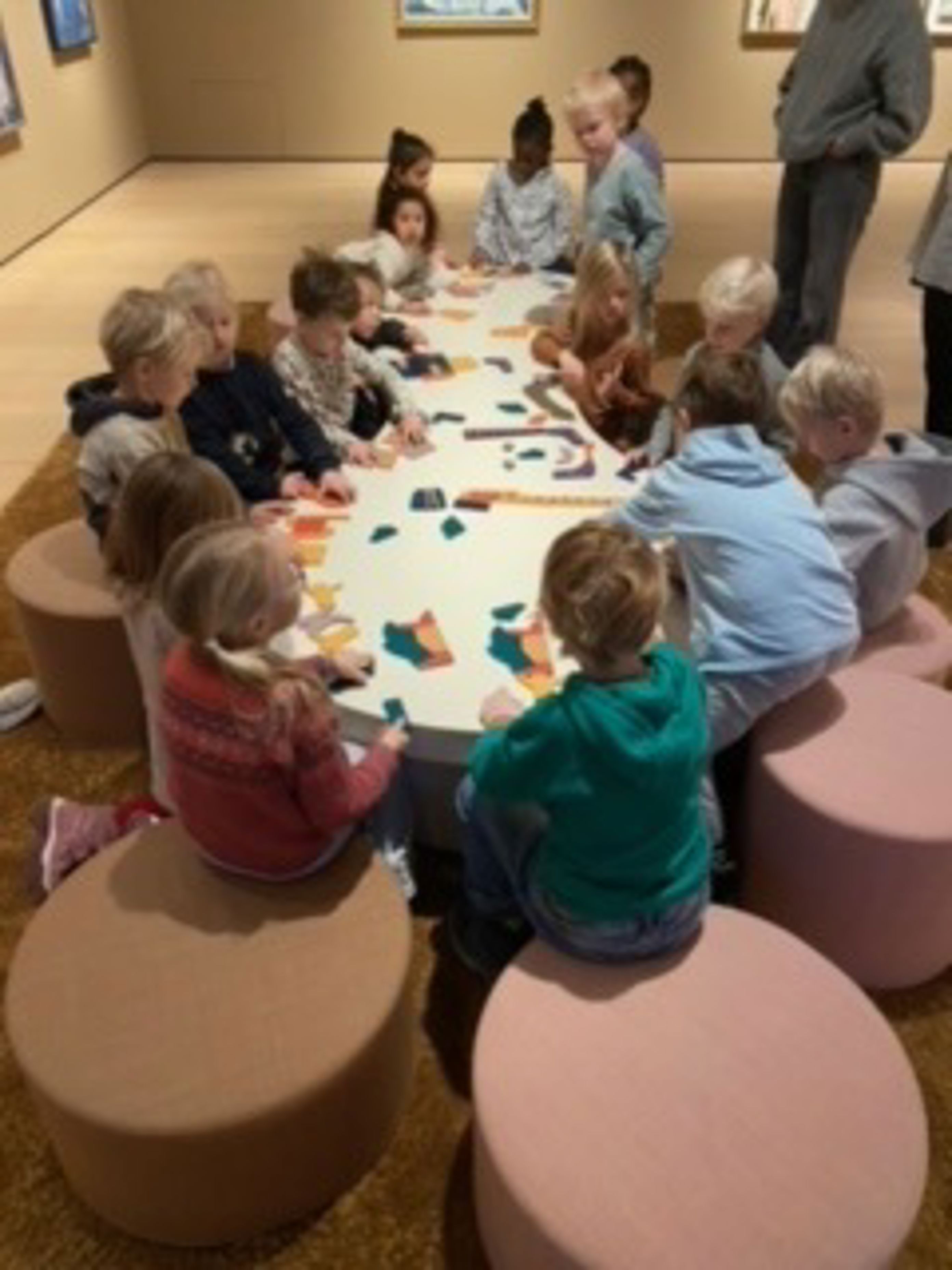 en gruppe barn som sitter rundt et bord