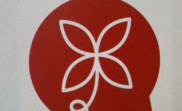 en rød sirkel med et hvitt symbol