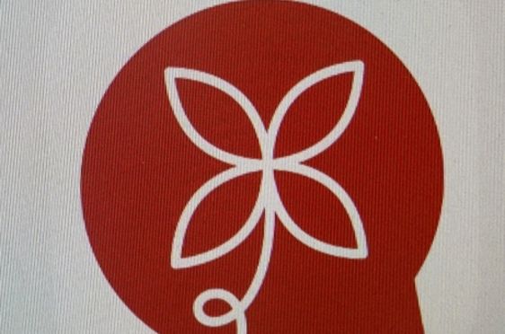 en rød sirkel med et hvitt symbol